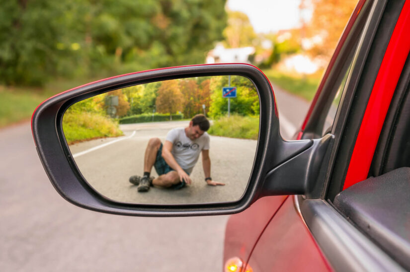 View through a side mirror where a person with a knee injury 