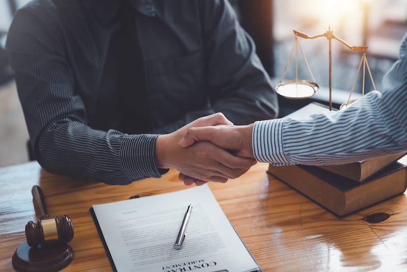 Attorney and client shaking hands Attorney and client shaking hands