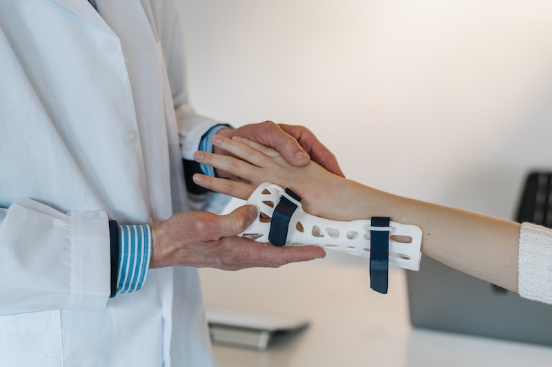 Doctor putting a cast on a patients arm