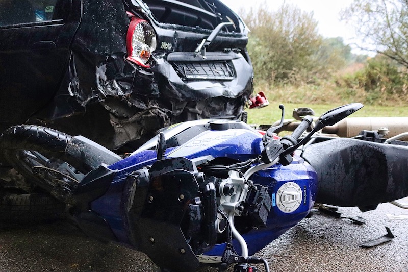 Motorcycle and a car in a crash