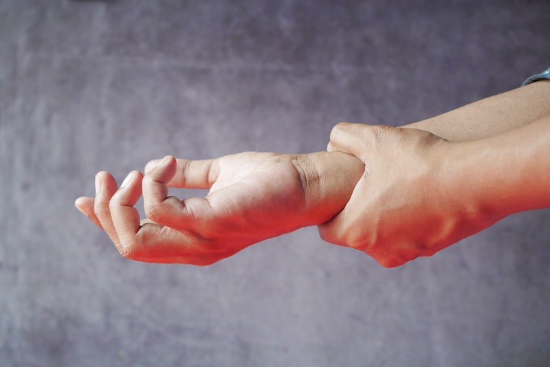 A person holding his arm in pain